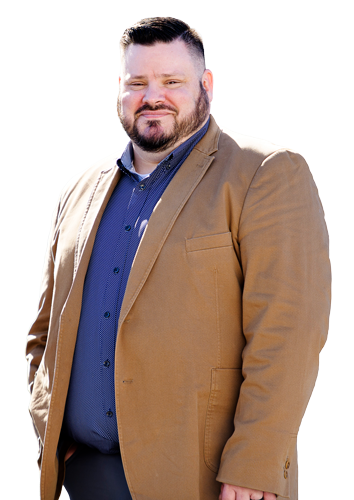 Warrior Jake Norotsky smiles, wearing a tan blazer over a blue collared shirt.