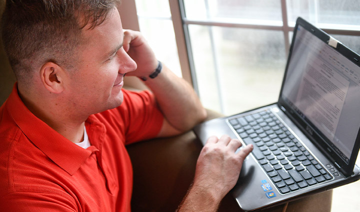 Wounded warrior Mike Heller works on his laptop.