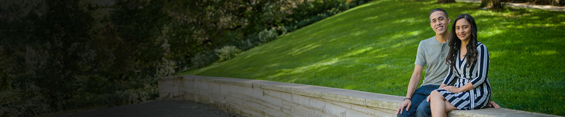 Wounded warrior Sergio Alfaro and wife Christina sitting outside on a stone wall