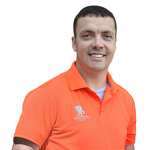 Warrior Jack Frawley smiles while wearing a bright orange Wounded Warrior Project polo.