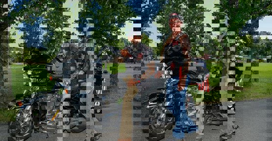 Wounded warrior Ray Andalio and his wife Deedra sitting on a motorcycle.