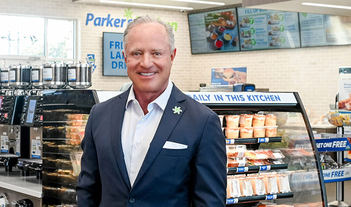 Parker’s Kitchen CEO Greg Parker smiles while standing in one of his stores.