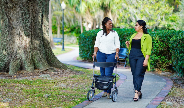 Wounded warriors Sharona Young and Yomari Cruz walk in the park while having a conversation.